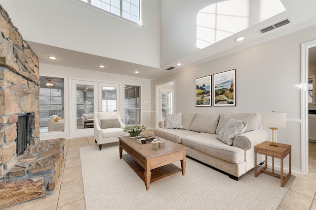 living area featuring visible vents, ornamental molding, and french doors