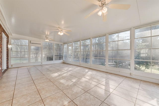 unfurnished sunroom with ceiling fan and a wall mounted AC