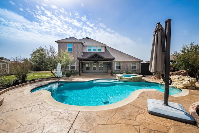 view of pool with a pool with connected hot tub and a patio