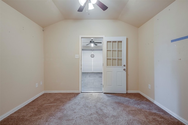 empty room featuring lofted ceiling, ceiling fan, and carpet