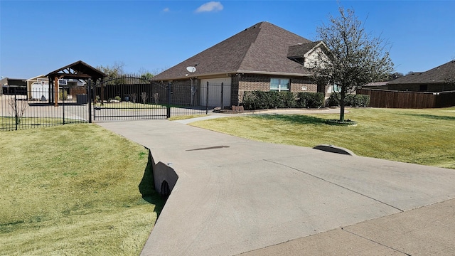 view of front facade with brick siding, a shingled roof, a front lawn, fence, and a gate