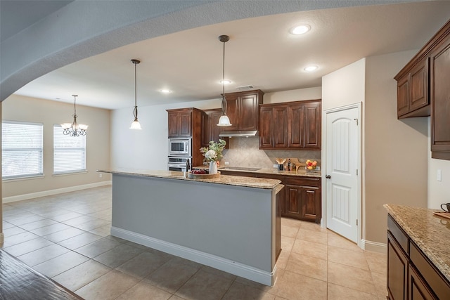 kitchen with under cabinet range hood, appliances with stainless steel finishes, backsplash, and recessed lighting