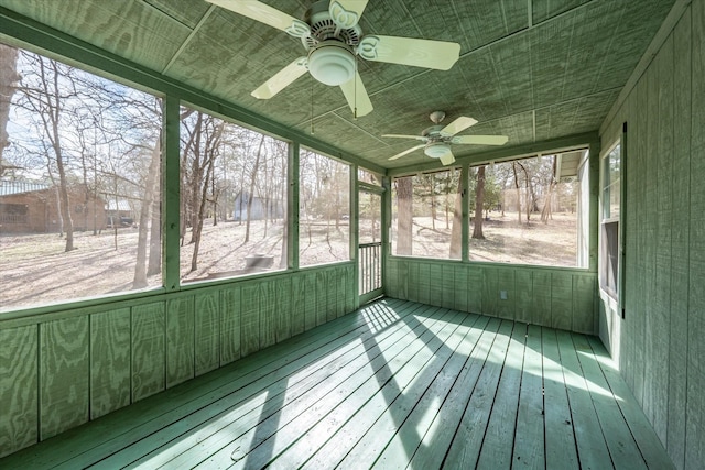 unfurnished sunroom featuring ceiling fan