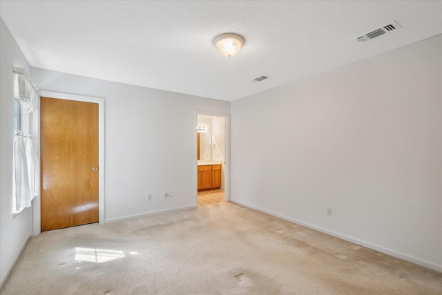 2682 Holly Trl E, Holly Lake Ranch, TX 75765 - unfurnished bedroom with light carpet, baseboards, and connected bathroom