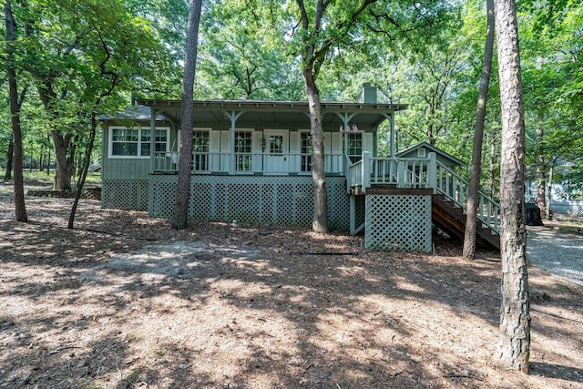 2682 Holly Trl E, Holly Lake Ranch, TX 75765 - view of front of house with covered porch, stairway, and a chimney