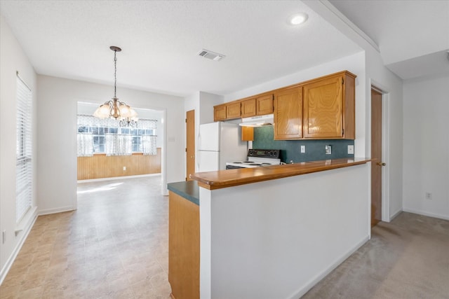 2682 Holly Trl E, Holly Lake Ranch, TX 75765 - kitchen with range with electric cooktop, freestanding refrigerator, under cabinet range hood, a chandelier, and healthy amount of natural light