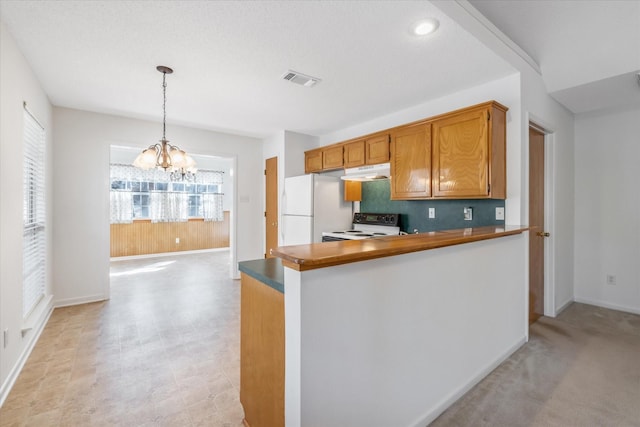 kitchen featuring pendant lighting, brown cabinets, a chandelier, white appliances, and under cabinet range hood