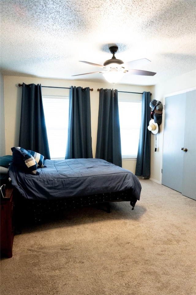 7409 Kingswood Dr, Fort Worth, TX 76133 - bedroom with a textured ceiling, a ceiling fan, and light colored carpet