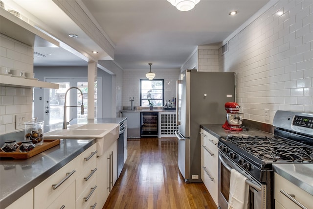 kitchen with dark wood-type flooring, appliances with stainless steel finishes, wine cooler, and backsplash