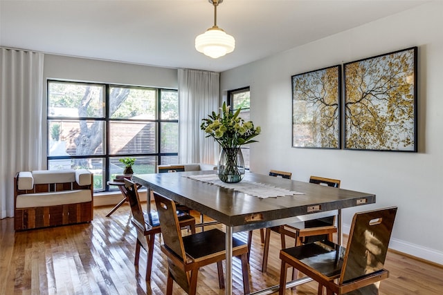 dining space with wood finished floors and baseboards