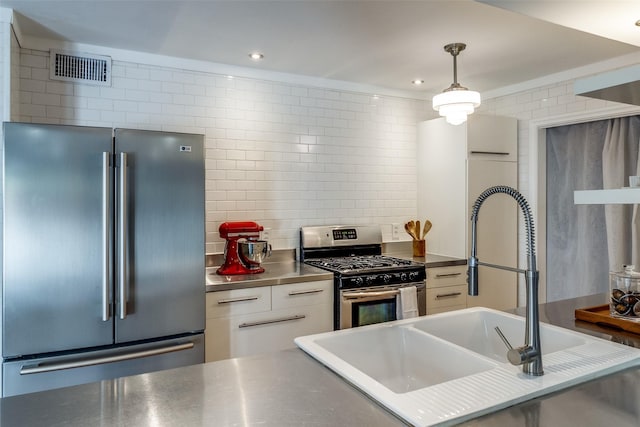 kitchen featuring a sink, visible vents, white cabinetry, appliances with stainless steel finishes, and stainless steel counters