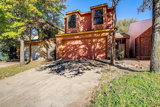 6327 Benavides Dr, Dallas, TX 75217 - view of front of home featuring driveway, an attached garage, and brick siding