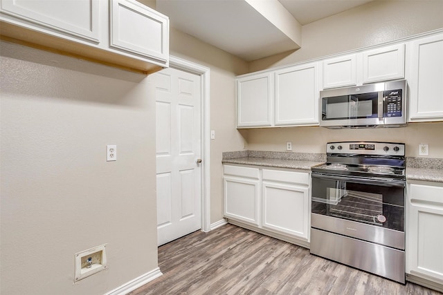 kitchen featuring stainless steel appliances, light wood-type flooring, and white cabinets