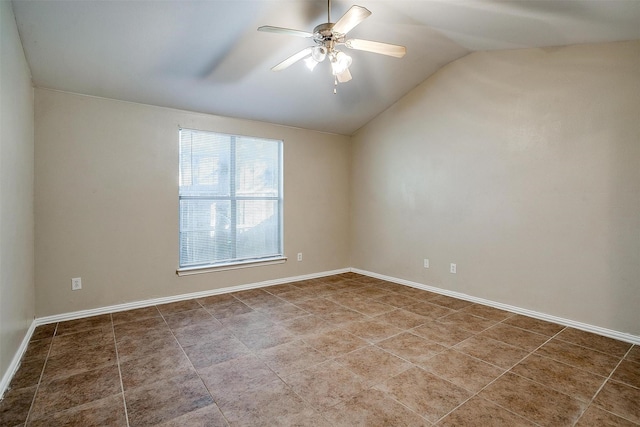 tiled spare room featuring lofted ceiling, ceiling fan, and baseboards