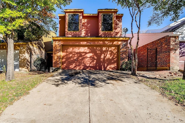 view of front of house featuring concrete driveway, brick siding, and an attached garage