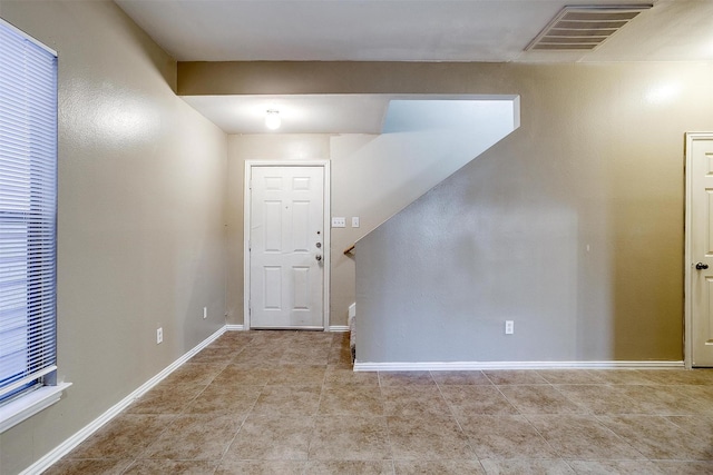 entryway with visible vents, baseboards, and tile patterned floors