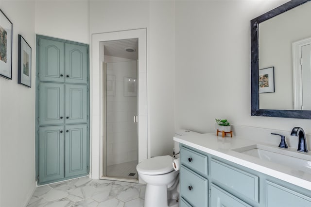 full bath with toilet, marble finish floor, a stall shower, and vanity