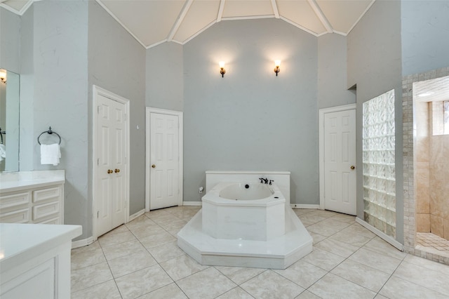 bathroom featuring tile patterned flooring, vanity, a garden tub, ornamental molding, and high vaulted ceiling