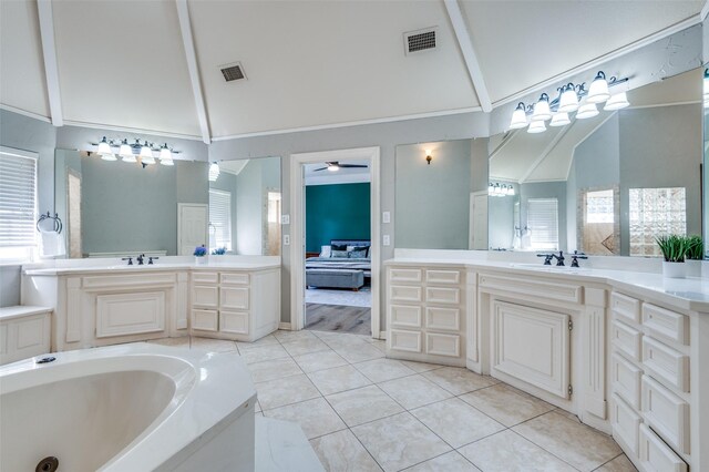 full bathroom with visible vents, lofted ceiling, a ceiling fan, and tile patterned flooring