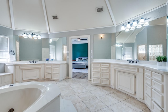 3605 Wexford Ct, Colleyville, TX 76034 - bathroom with plenty of natural light, tile patterned floors, high vaulted ceiling, ceiling fan, and a garden tub