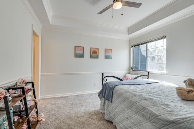 bedroom with a raised ceiling, crown molding, and carpet floors