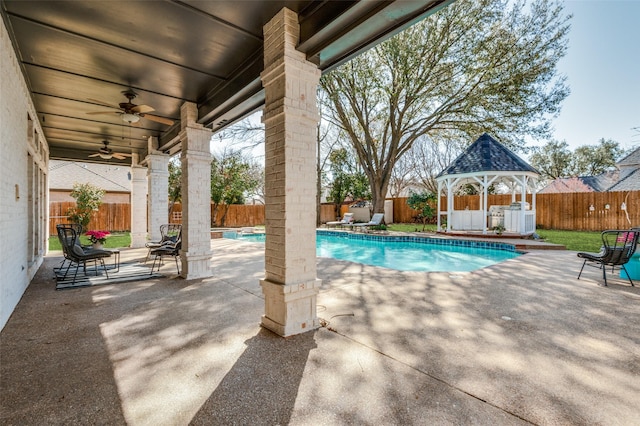 view of swimming pool with a fenced in pool, a patio, a fenced backyard, and a ceiling fan