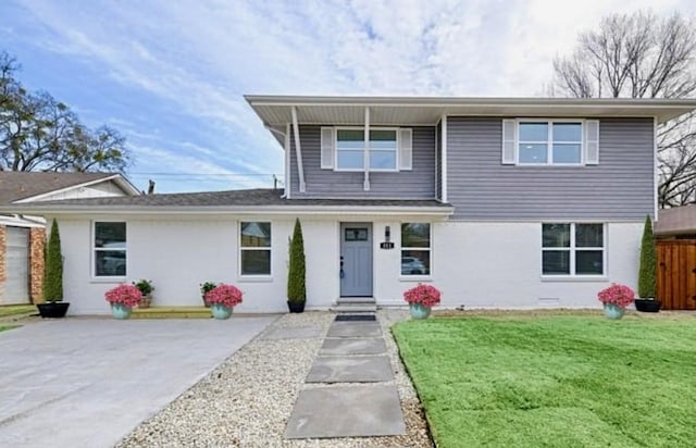 view of front of home with a front yard and fence