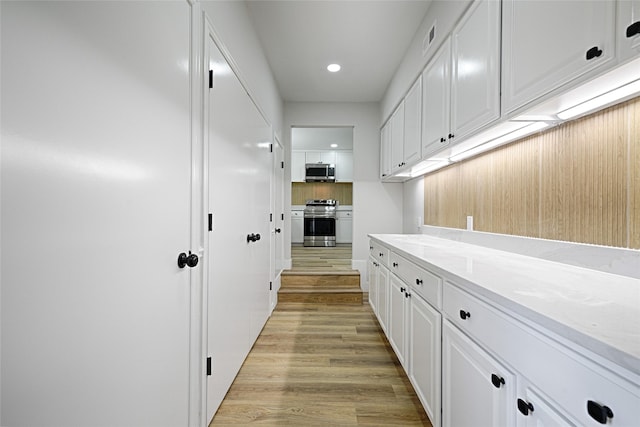 interior space with light wood-type flooring, visible vents, and recessed lighting