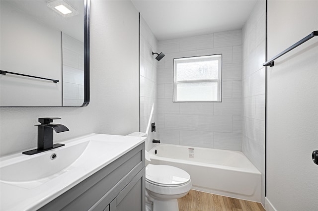 bathroom featuring vanity,  shower combination, wood finished floors, and toilet