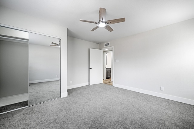 unfurnished bedroom featuring ceiling fan, carpet floors, a closet, and baseboards