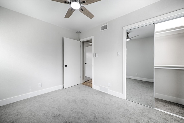 unfurnished bedroom featuring baseboards, carpet, visible vents, and a closet