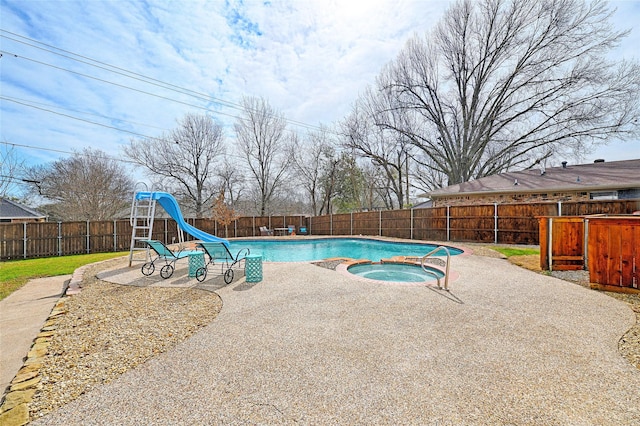 view of pool featuring a fenced in pool, a patio area, an in ground hot tub, a water slide, and a fenced backyard