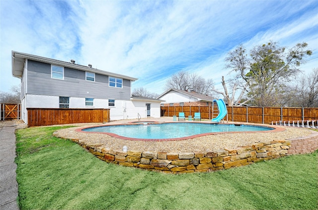 view of swimming pool featuring a yard, a water slide, a fenced backyard, and a fenced in pool