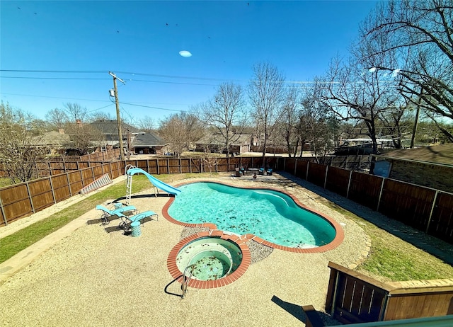 view of swimming pool featuring a patio, a water slide, a fenced backyard, and a fenced in pool