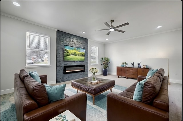 carpeted living area with recessed lighting, ornamental molding, ceiling fan, a stone fireplace, and baseboards