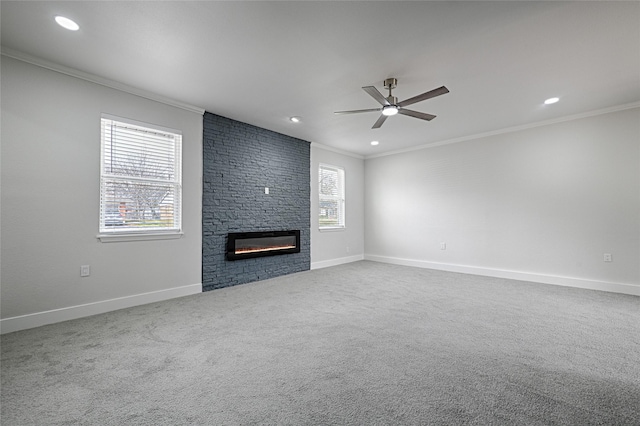 unfurnished living room featuring a large fireplace, baseboards, and ornamental molding