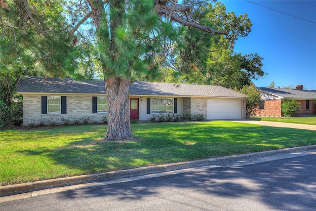 ranch-style home with a front lawn, driveway, and an attached garage