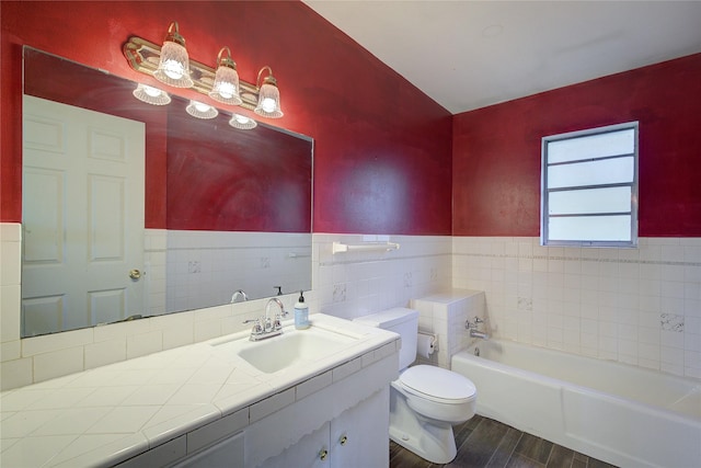 full bathroom featuring toilet, a washtub, wainscoting, and tile walls