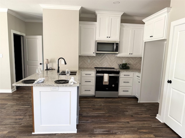 kitchen with white cabinets, tasteful backsplash, stainless steel appliances, and a sink