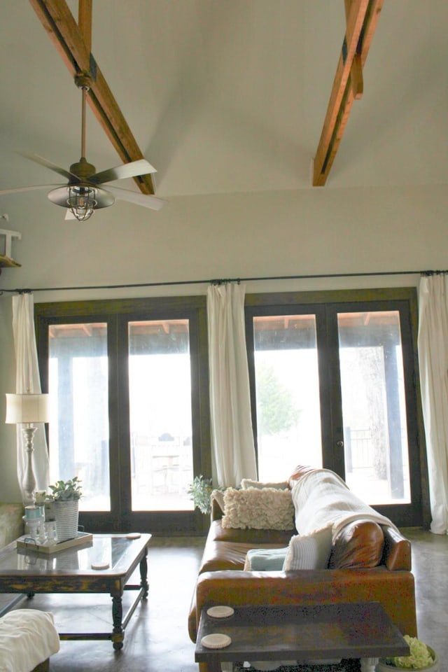 sunroom / solarium featuring lofted ceiling with beams, ceiling fan, a wealth of natural light, and french doors