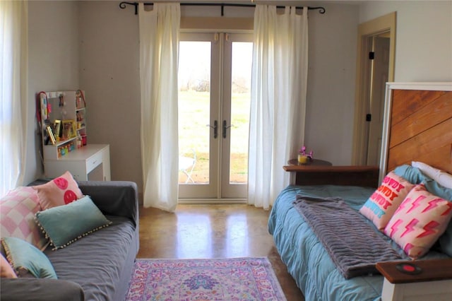 bedroom featuring access to exterior, wood finished floors, and french doors