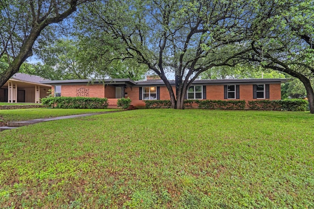 ranch-style house with brick siding and a front lawn