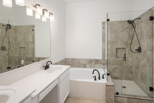 full bathroom featuring double vanity, a garden tub, a shower stall, and a sink