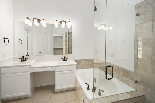 bathroom featuring a bath, tile patterned flooring, double vanity, and a sink