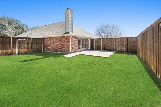 view of yard with a fenced backyard, a gate, and a patio