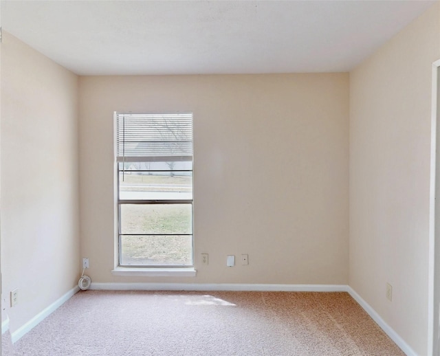 empty room with carpet flooring and baseboards