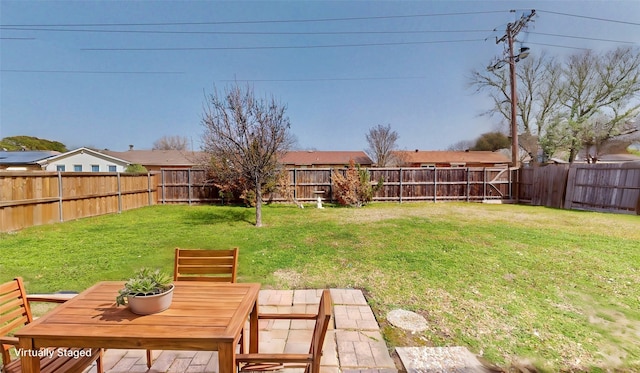 view of yard featuring outdoor dining space and a fenced backyard