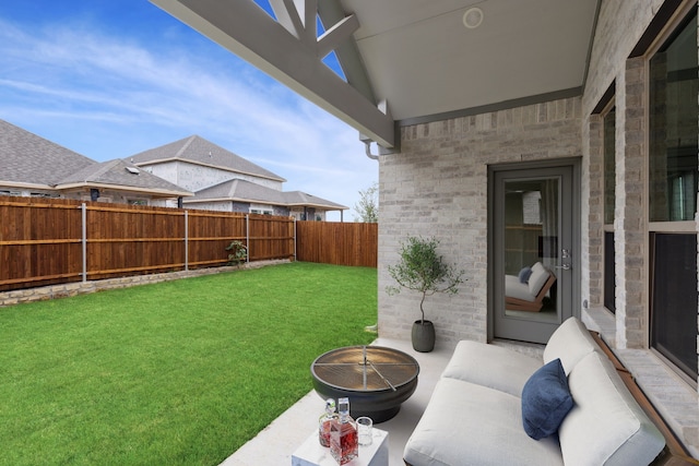 view of yard with an outdoor living space, a fenced backyard, and a patio area