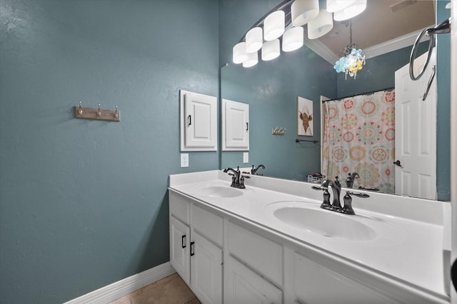 full bathroom with baseboards, tile patterned flooring, ornamental molding, and a sink