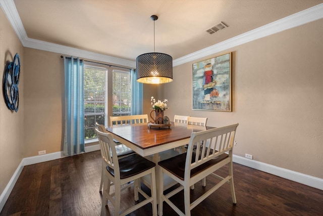 dining area with ornamental molding, wood finished floors, visible vents, and baseboards